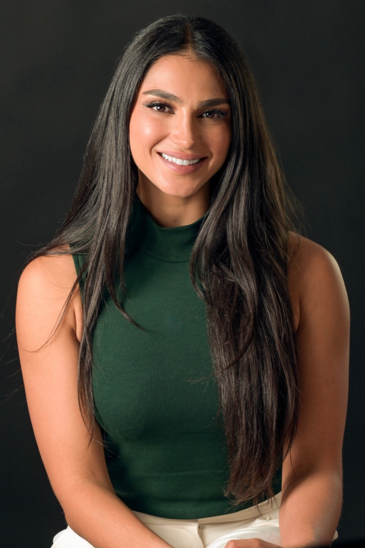 Hanah Al-Rashed, smiling, in a green top